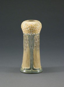 This diminutive vase topped with yellow phlox demonstrates Adelaide Alsop Robineau’s mastery of the porcelain process. Made at University City in 1910, the elaborately carved vase features cutout reticulations filled with translucent glaze. St. Louis Art Museum image